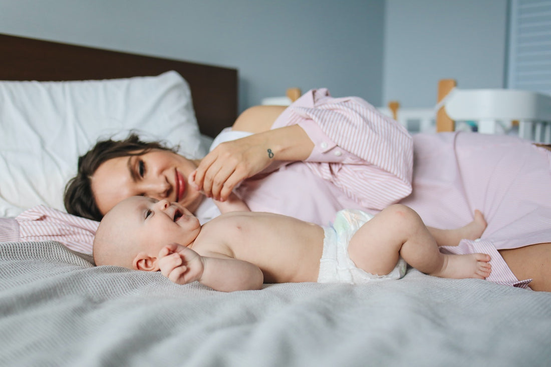 Maman allongée avec son bébé et une veilleuse pour bébé